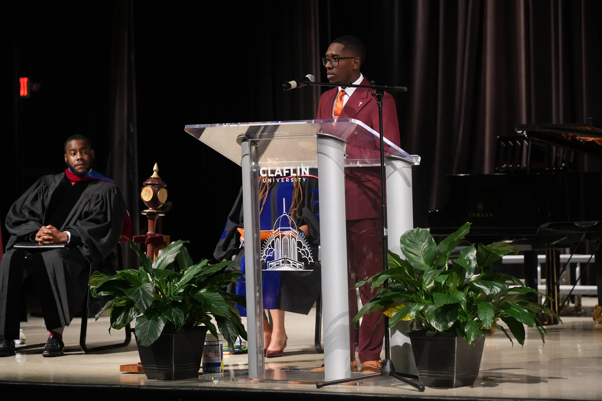 Claflin Student Government Association secretary speaking at a University podium