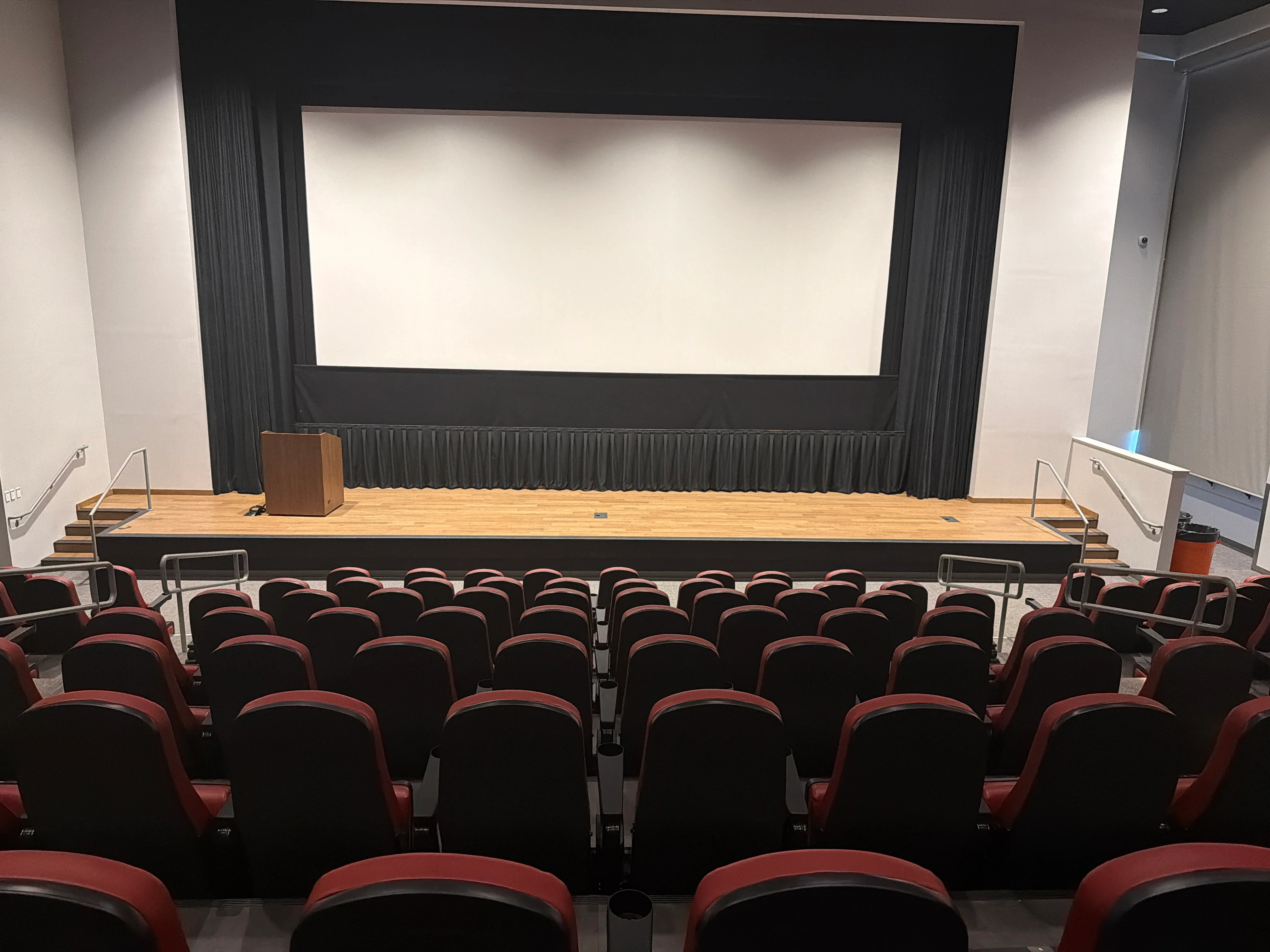 Centered view of the movie screen and stage from the middle seating area of the Nissan of Orangeburg Movie Theater