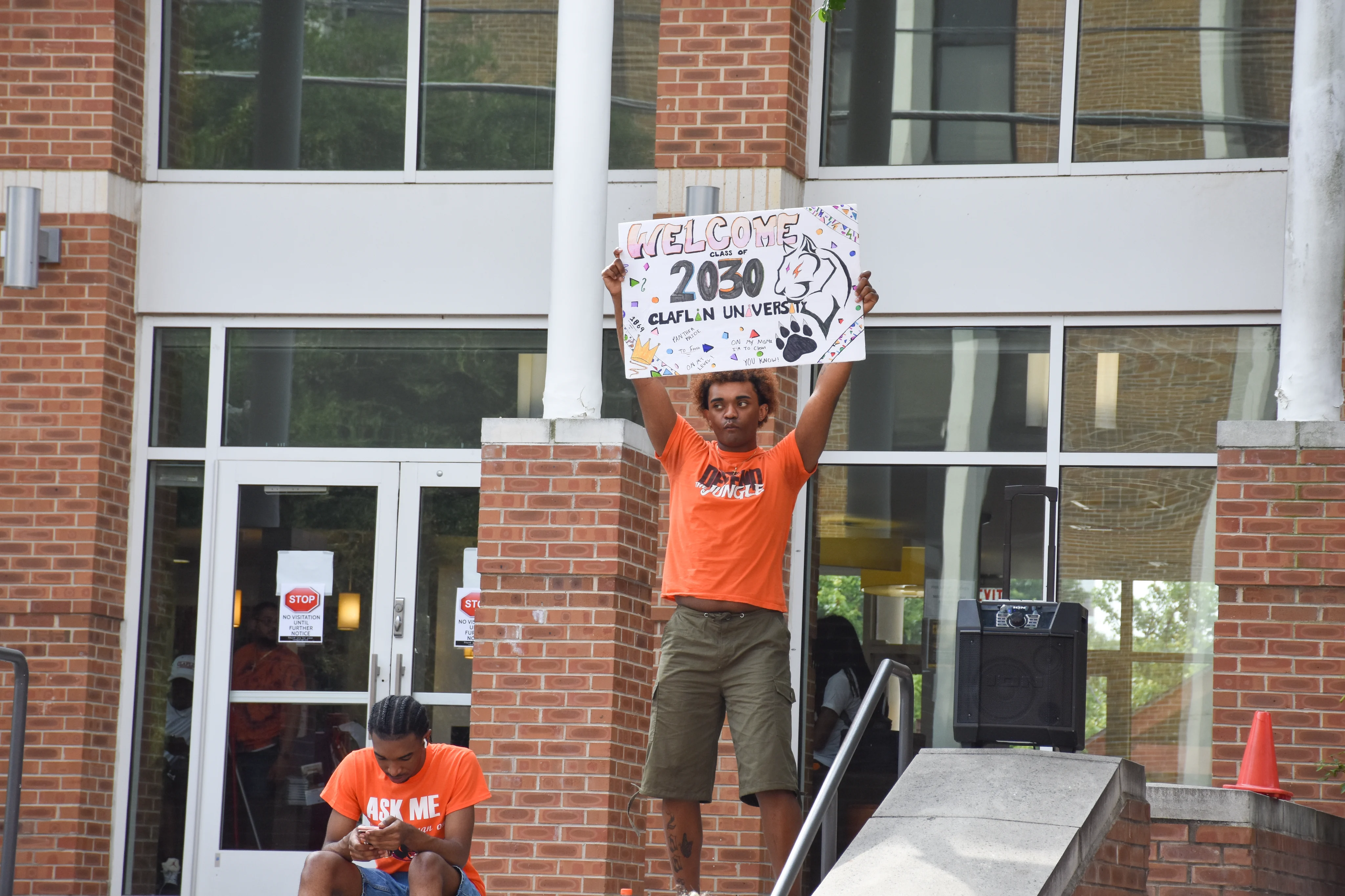 A Claflin student holding a sign welcoming the Class of 2030