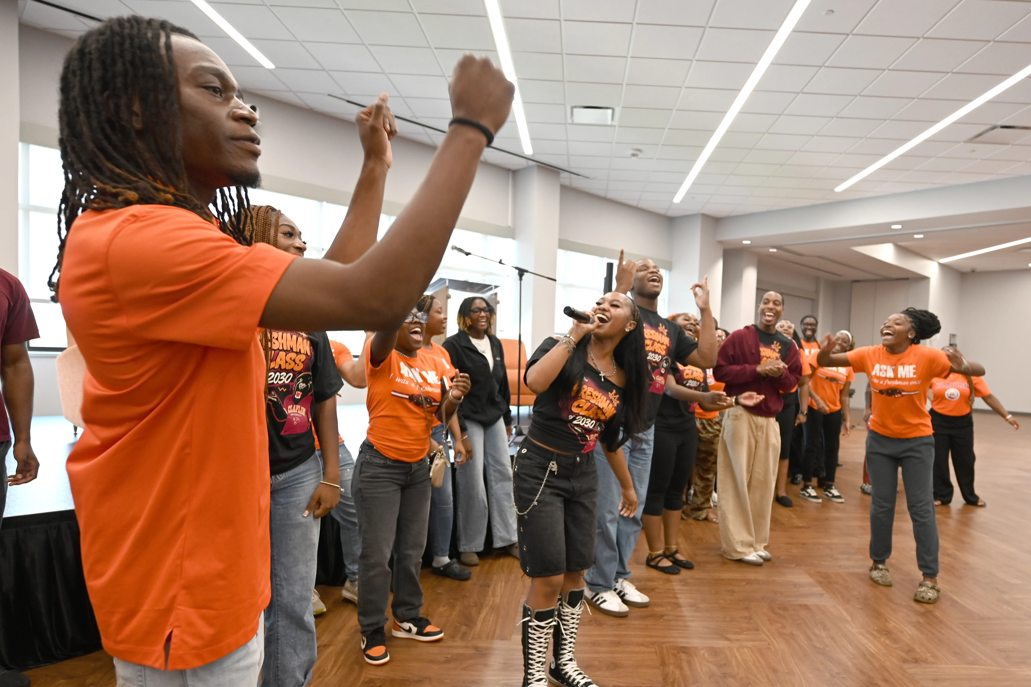 Claflin students singing, dancing, and cheering together at a social event