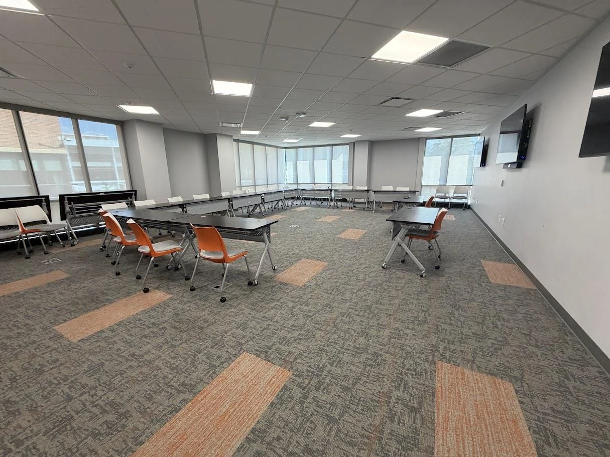Conference Room A with modular tables and orange chairs