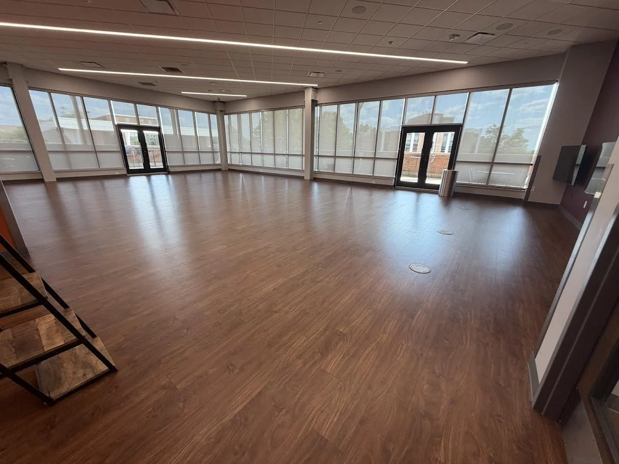Third-floor lounge with wood floors and floor-to-ceiling windows