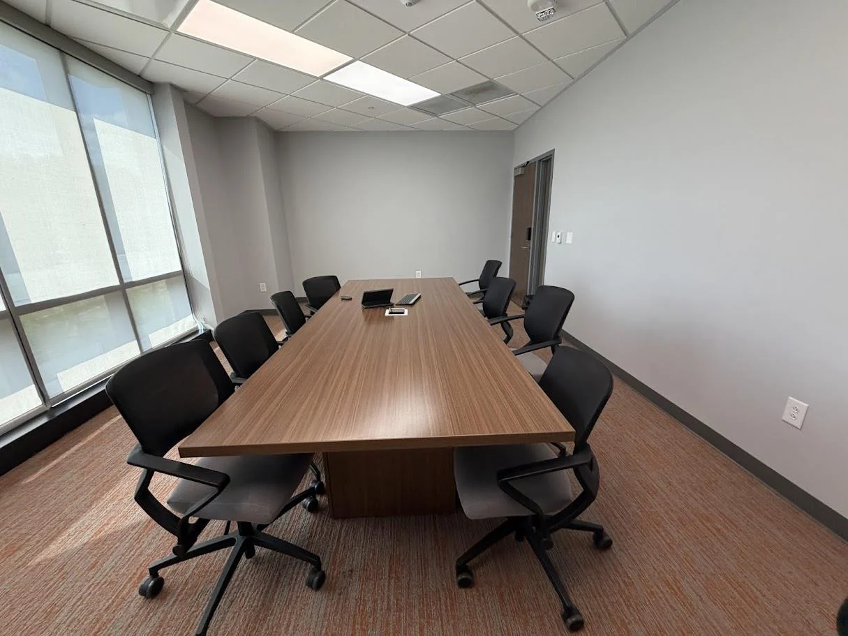 Conference Room C with a boardroom table and black chairs