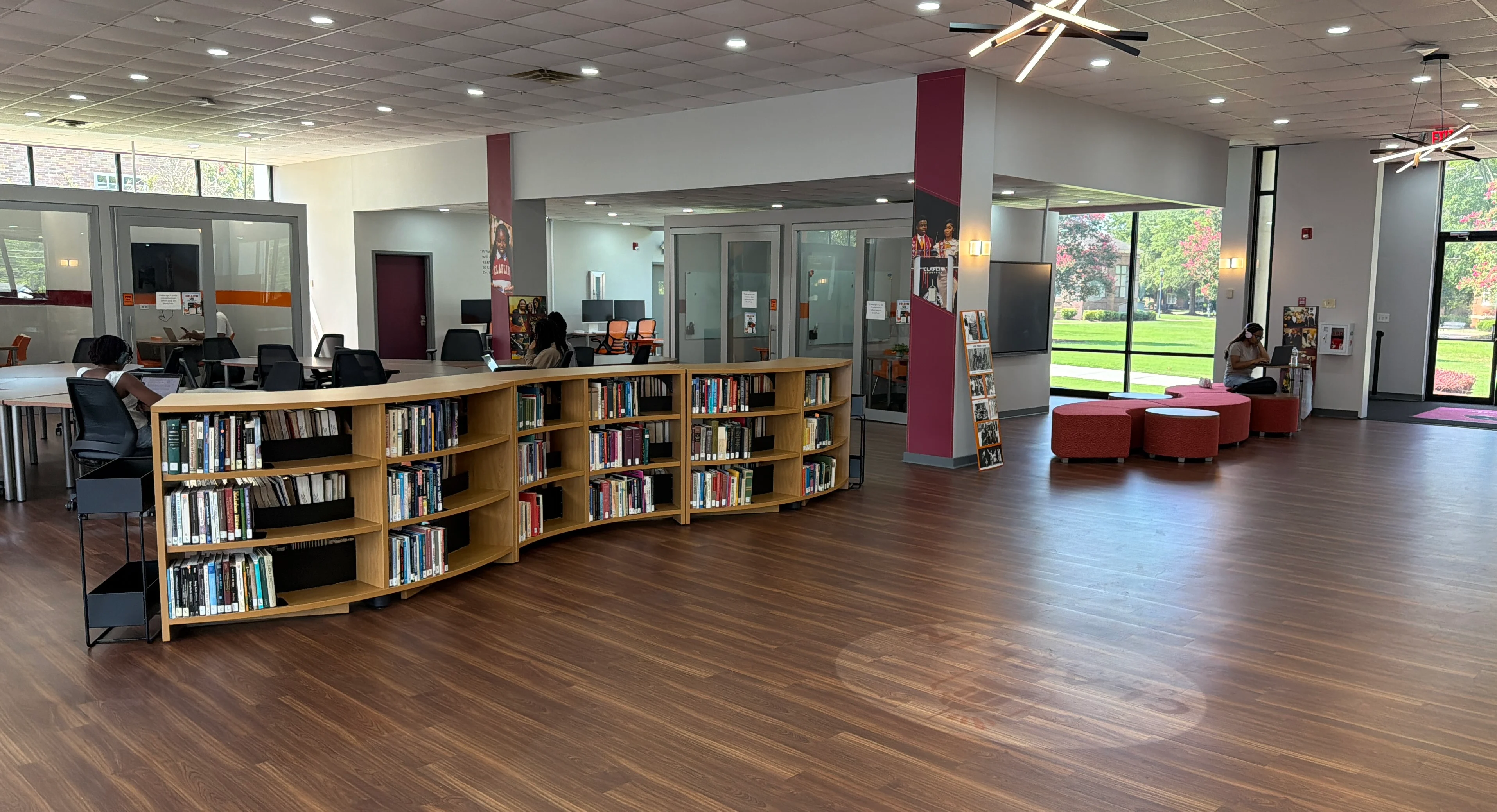 Bookshelves, computers, and collaborative seating inside the H.V. Manning Library