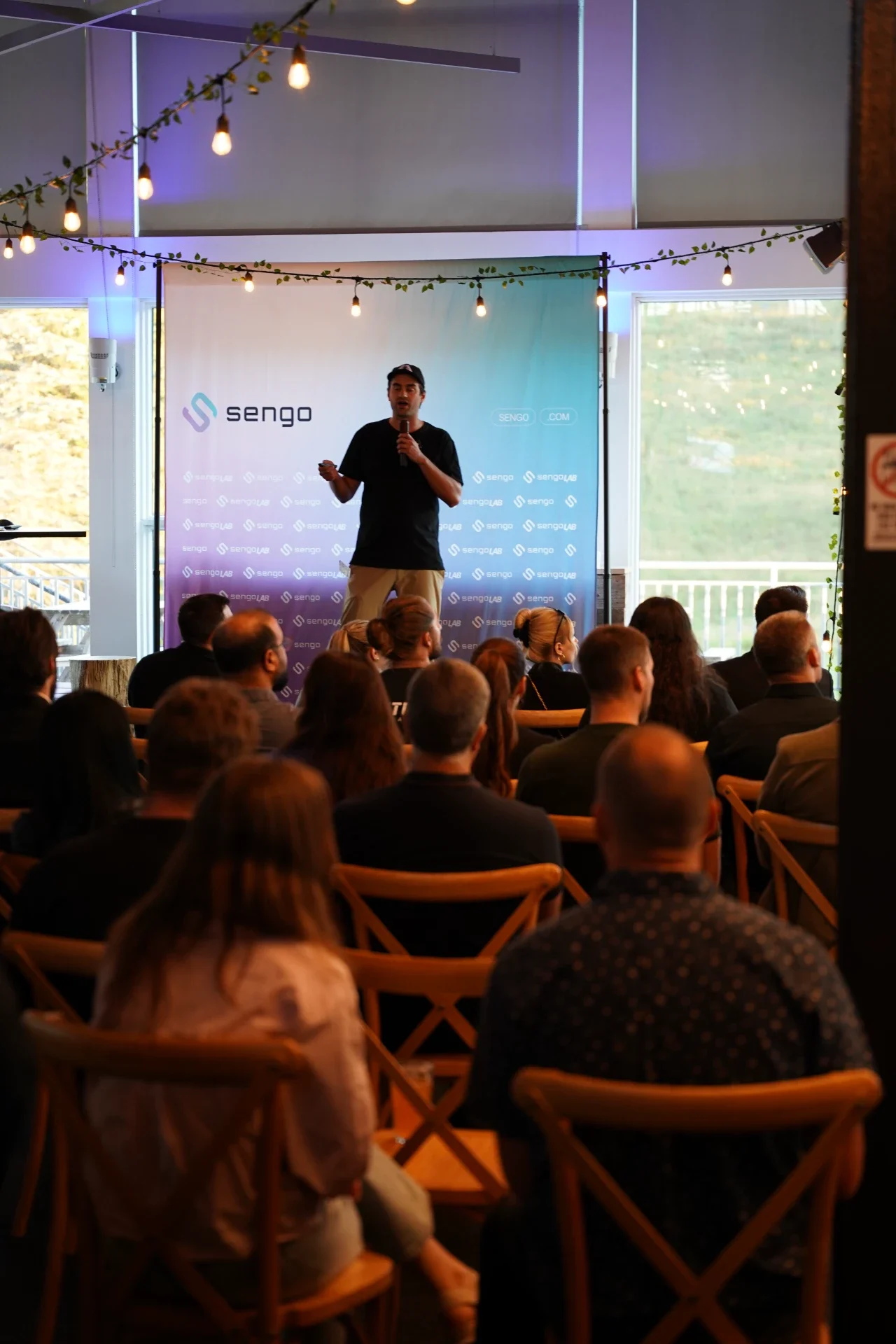 Talk in front of the Sengo backdrop at a Sengo Lab event