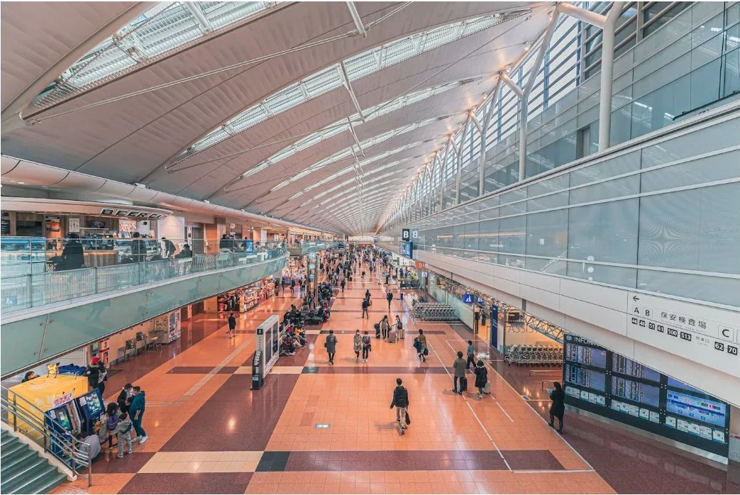 A bright airport concourse full of travelers