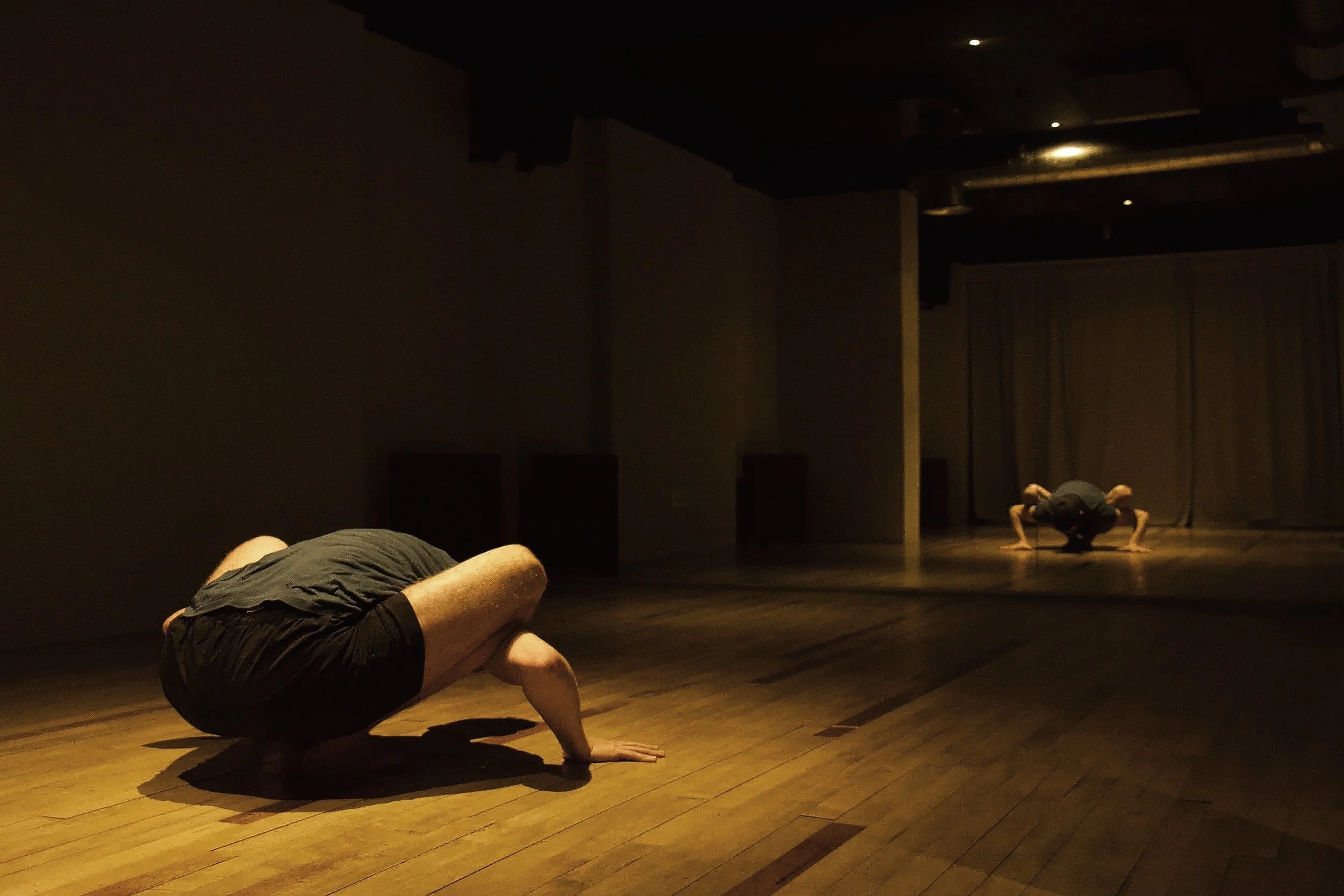 A student practising yoga on the wooden floor of the RebelStudio studio