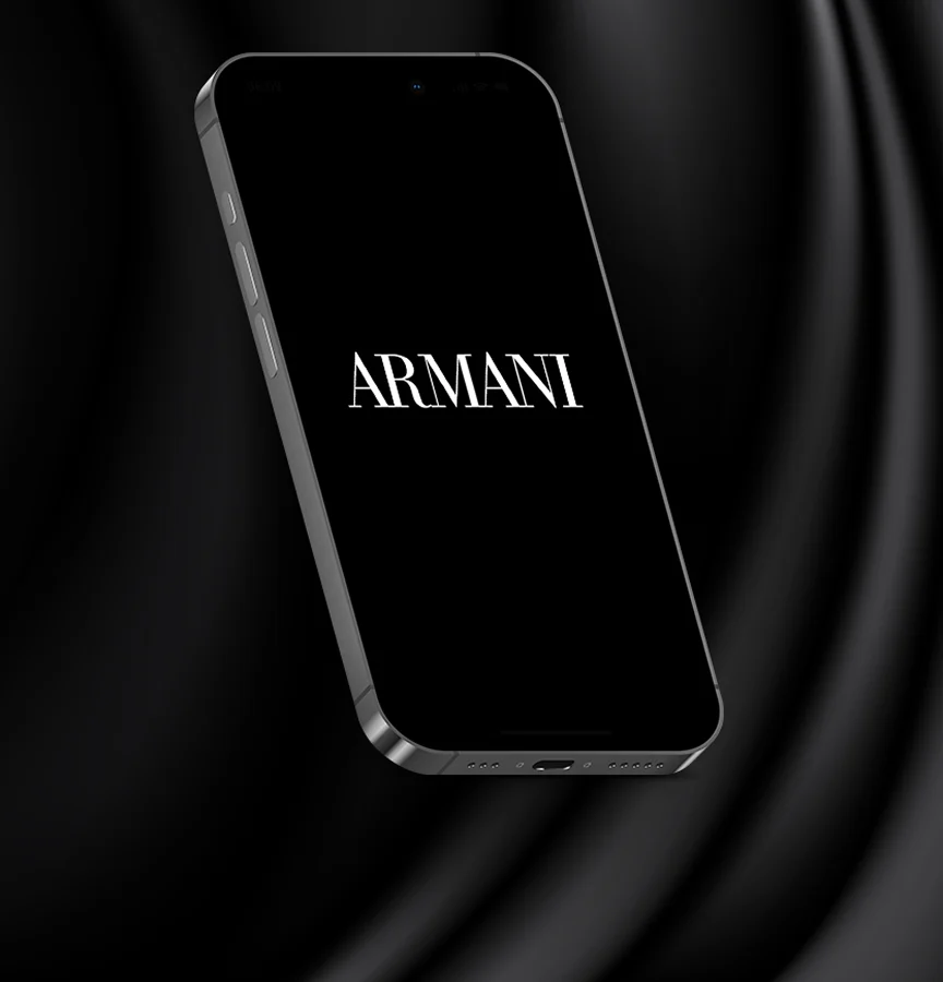 iPhone showing the Armani wordmark on a black silk background