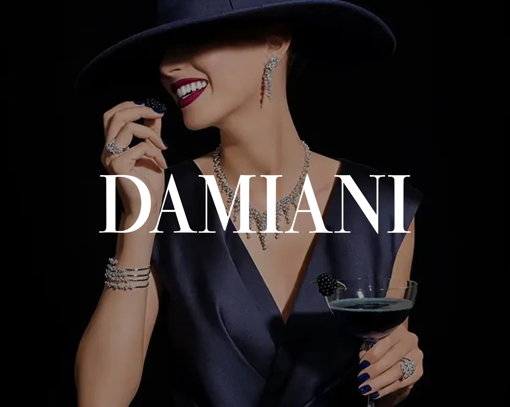 Damiani campaign image of a woman wearing a diamond necklace, earrings and rings, with the Damiani wordmark