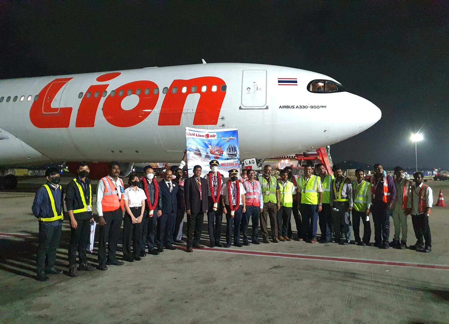 A Lion Air aircraft on stand with the ground handling team