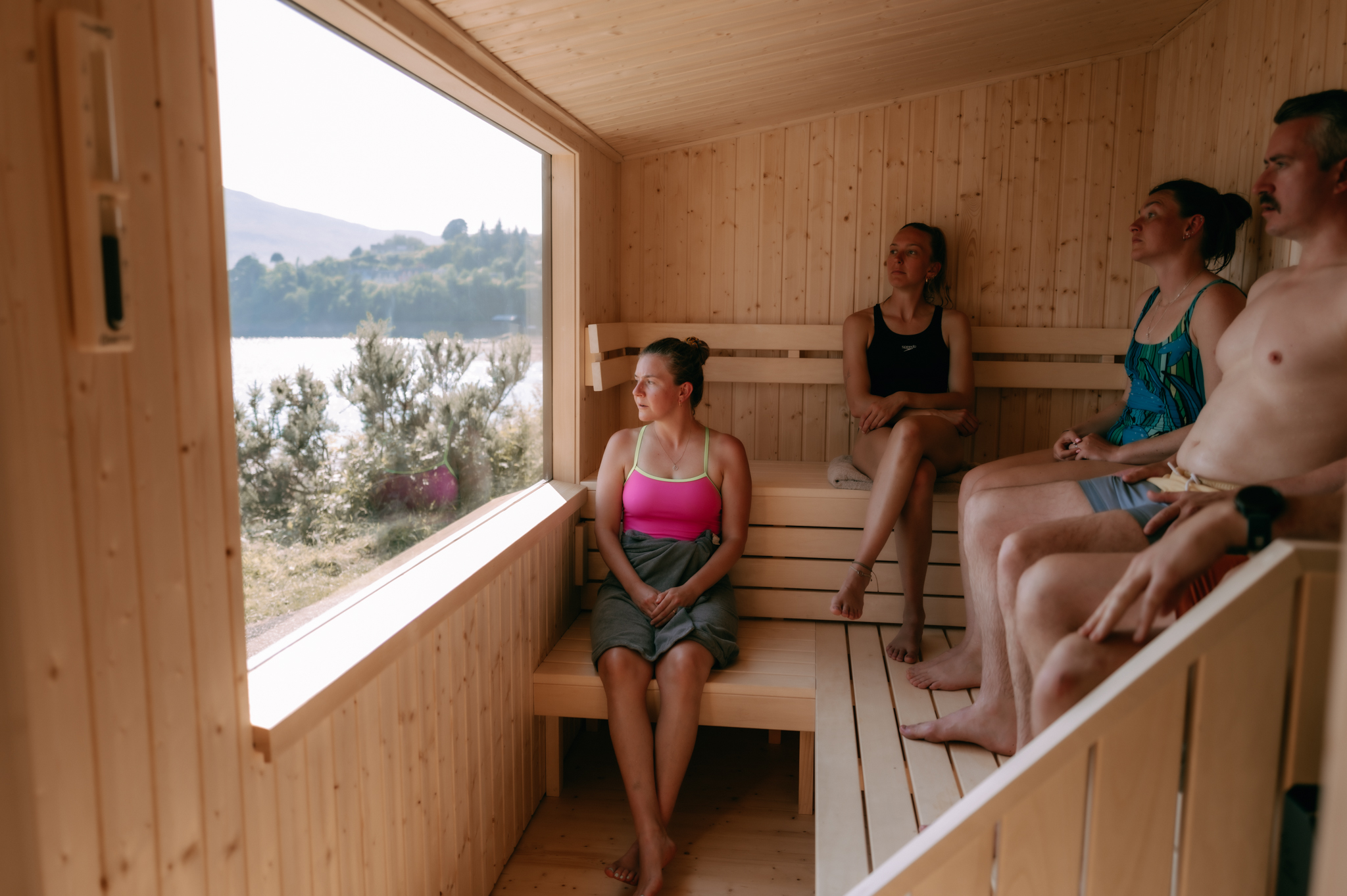 Guests relaxing inside Portree Sauna beside the harbour