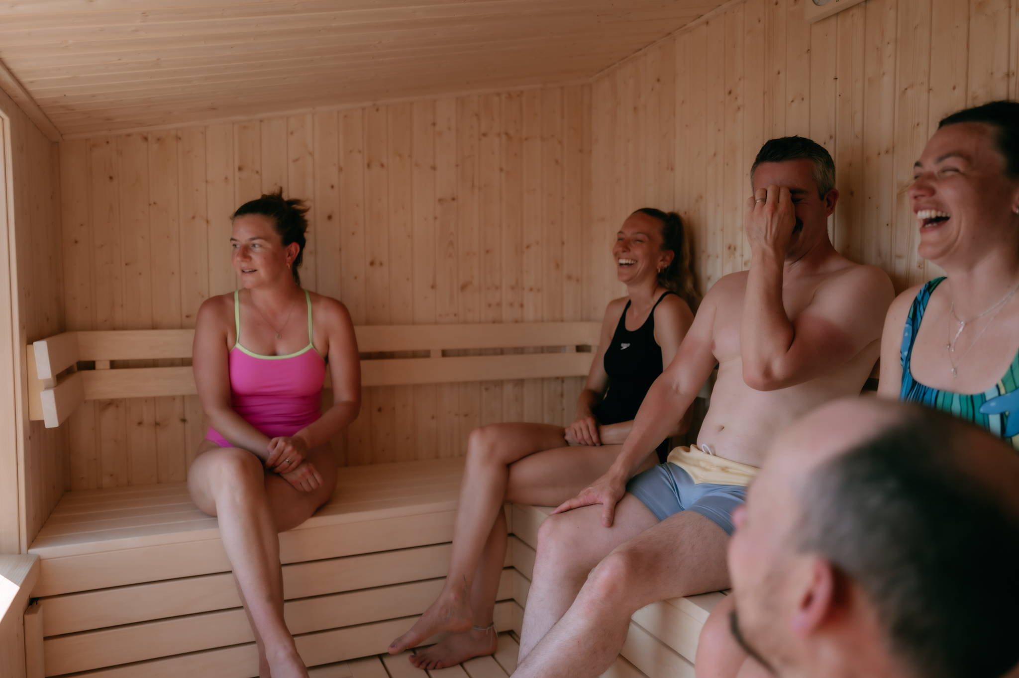 Guests sharing a wood-fired session inside Portree Sauna