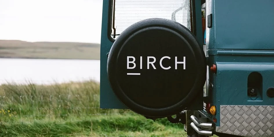 Birch Specialty Coffee's converted Land Rover Defender beside the water