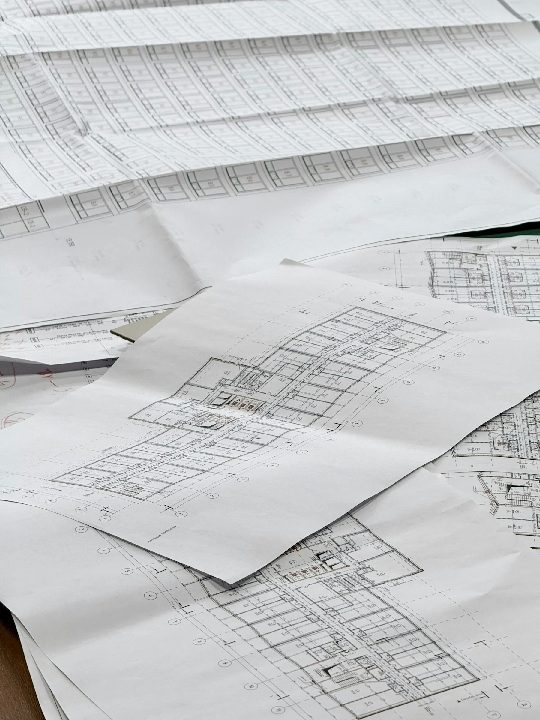 Architectural and planning drawings spread across a working table