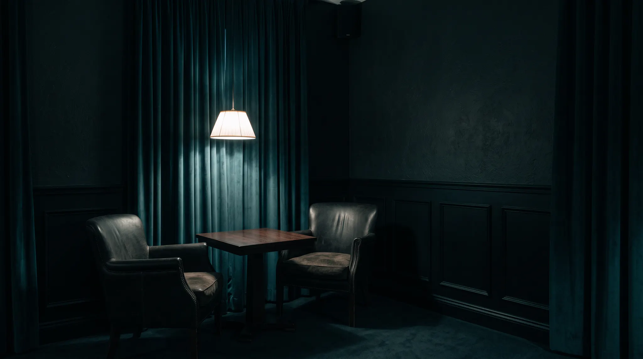 An empty table in a dim private lounge