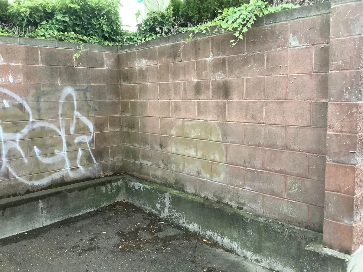 Brick retaining wall before graffiti removal