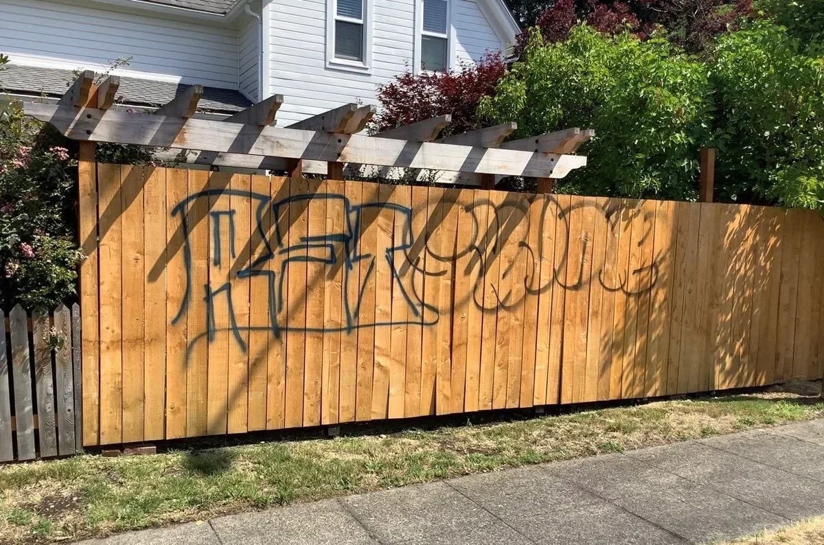 Wood fence before graffiti removal