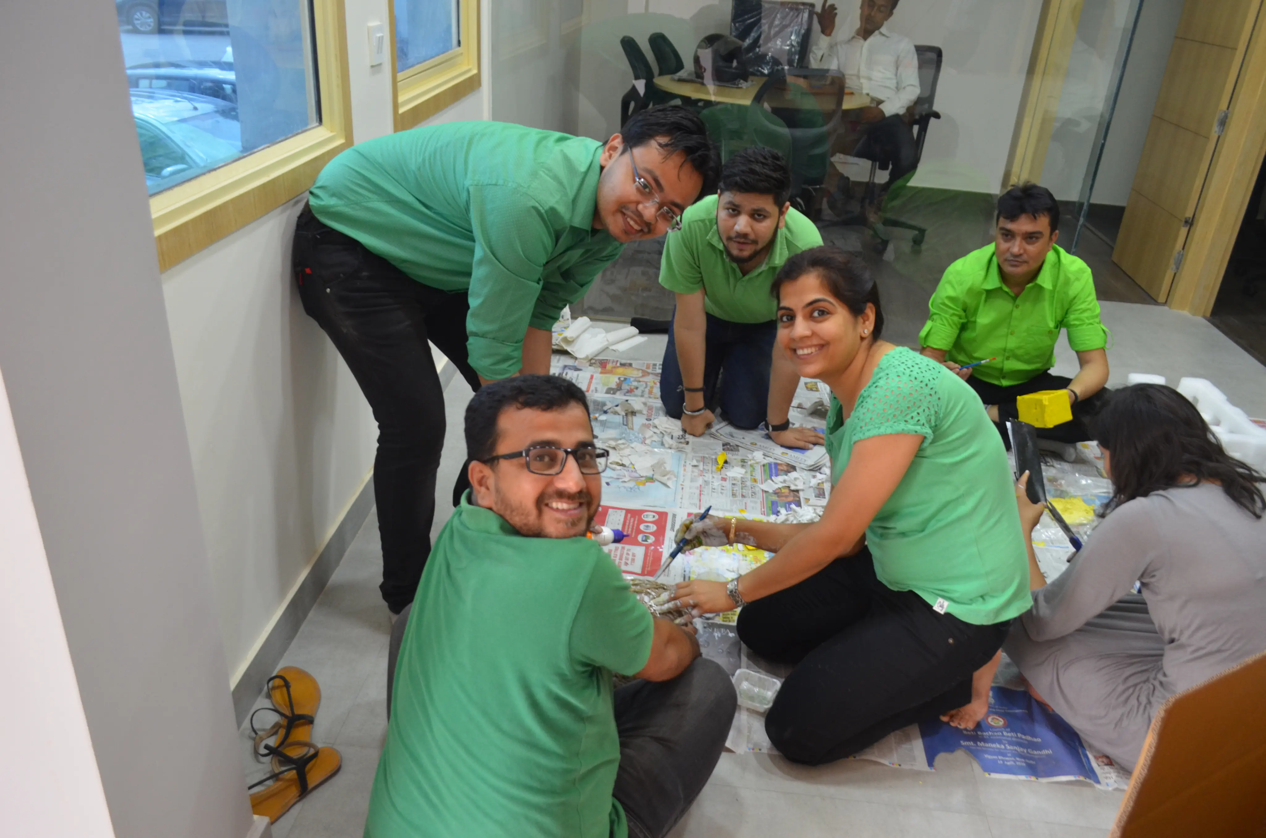 Colleagues collaborating on an Art from Junk activity