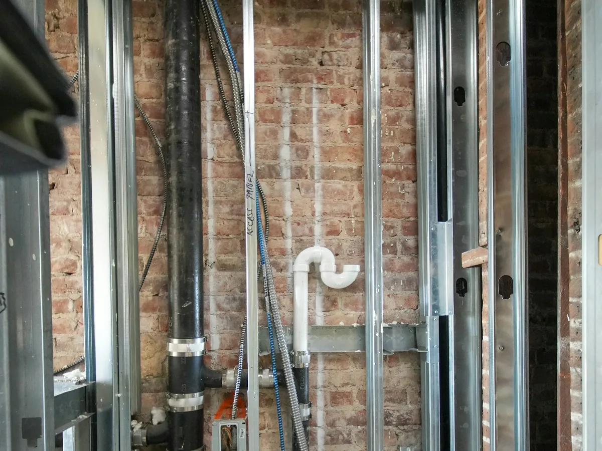 Exposed plumbing lines during a building renovation