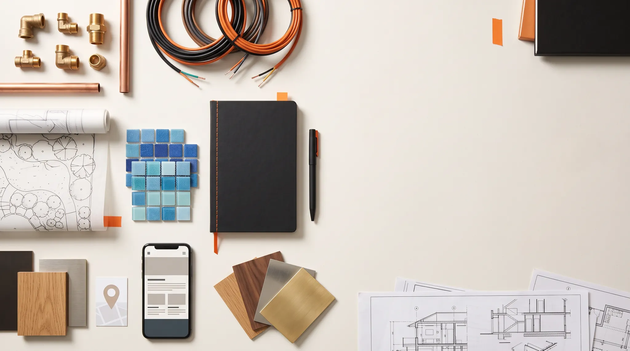 Trade materials, plans, and digital marketing tools arranged on a workbench