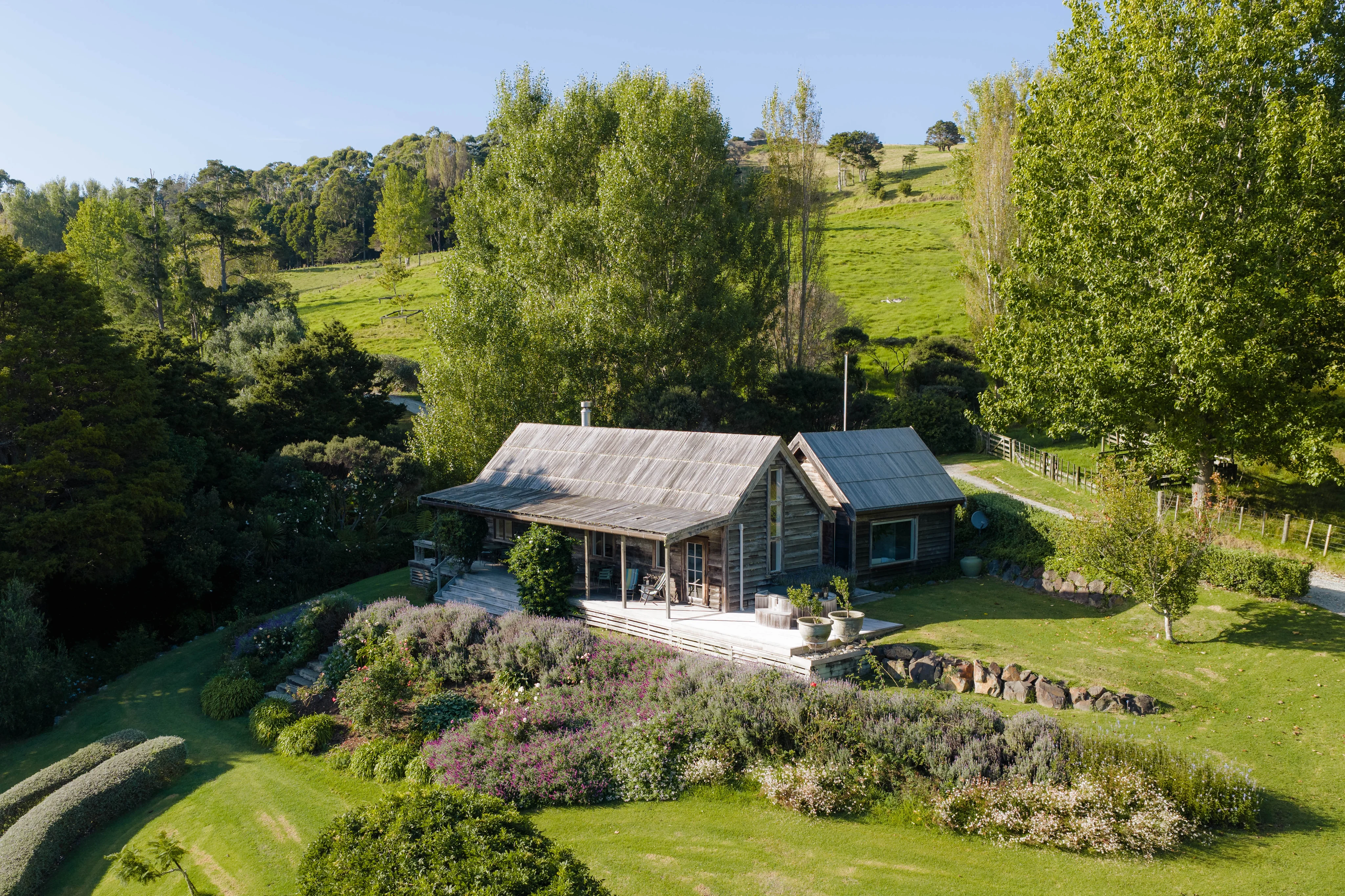 The Potting Shed surrounded by gardens and native bush