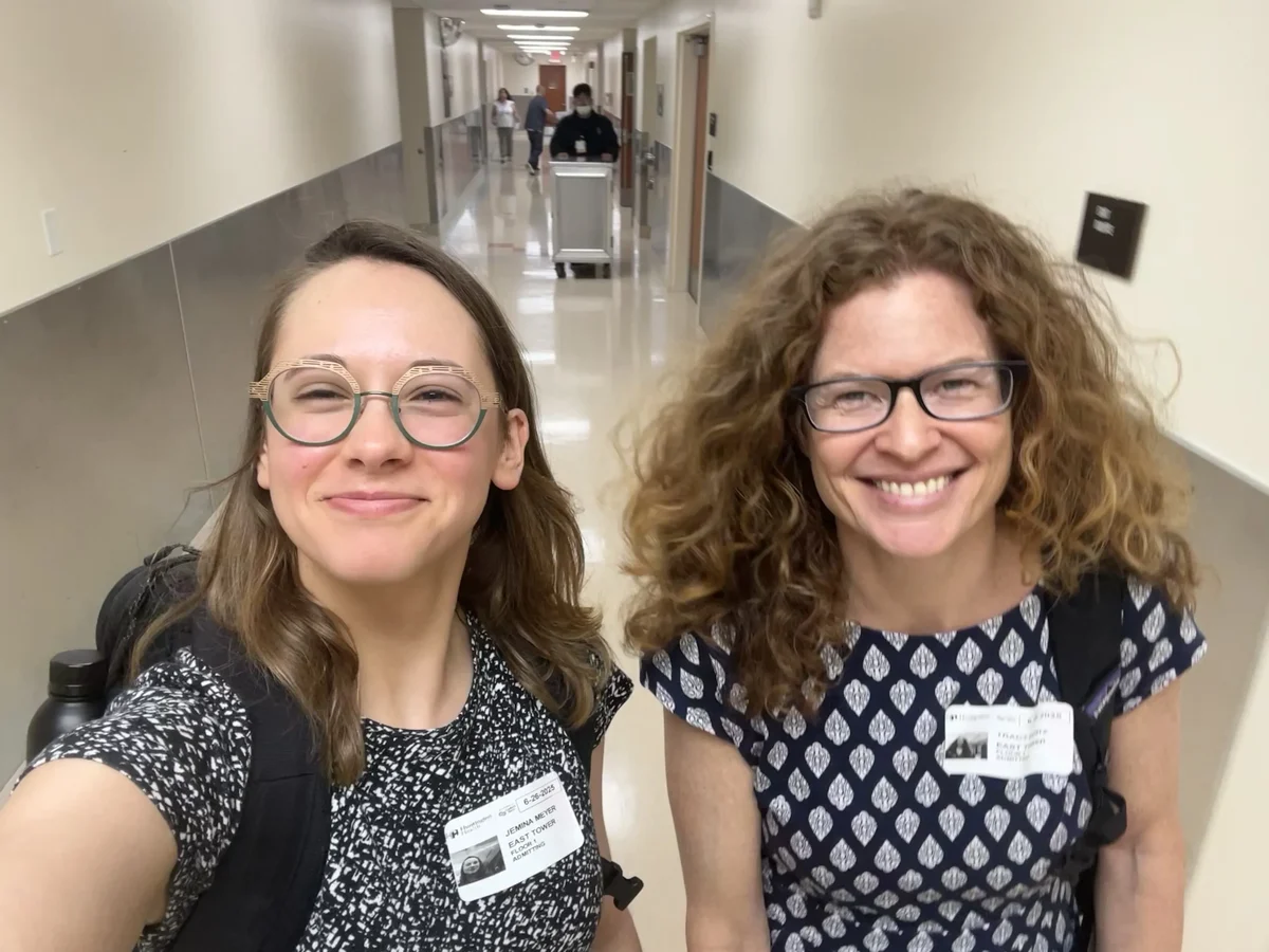 Two colleagues in a hospital hallway