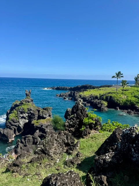 Black volcanic rock and bright blue water along Maui’s coastline