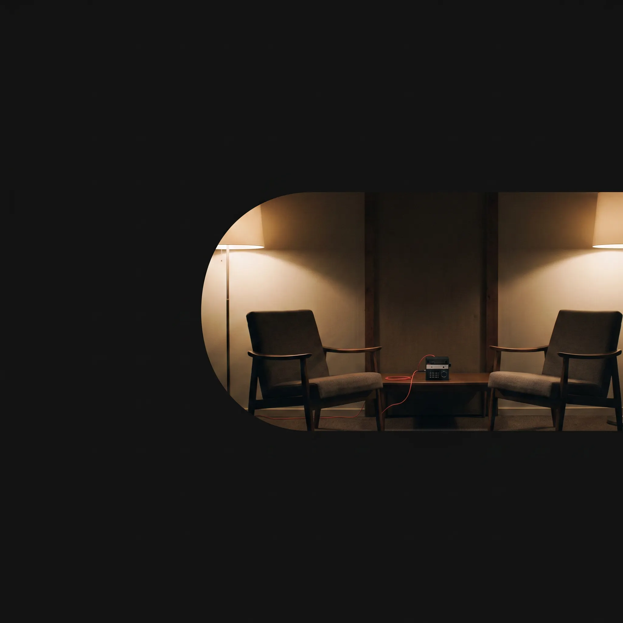 Two empty chairs and a recorder held inside one wide capsule scene