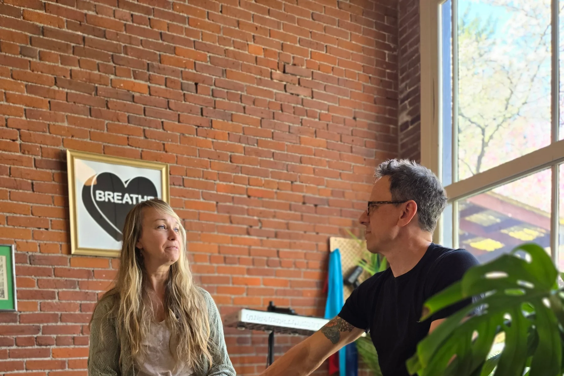 Jason Rinker in conversation with a patient at Riverside Acupuncture