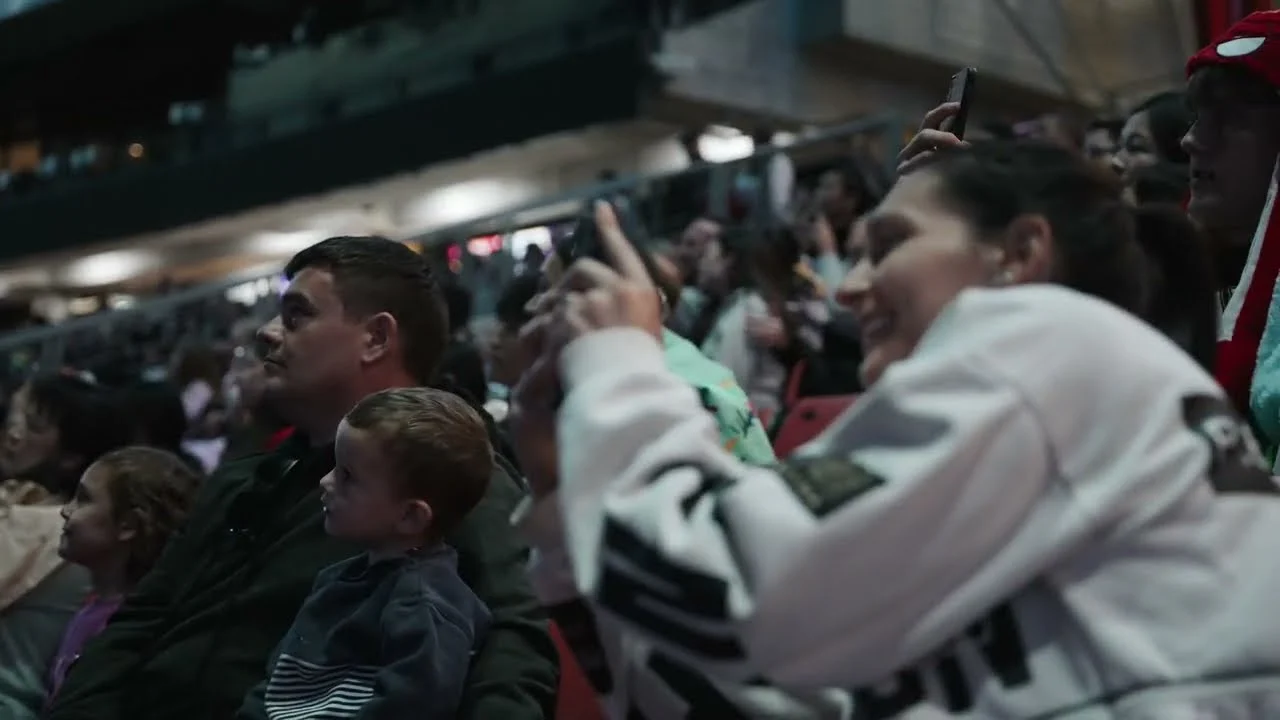 Fair audience looking up and filming an AURA show