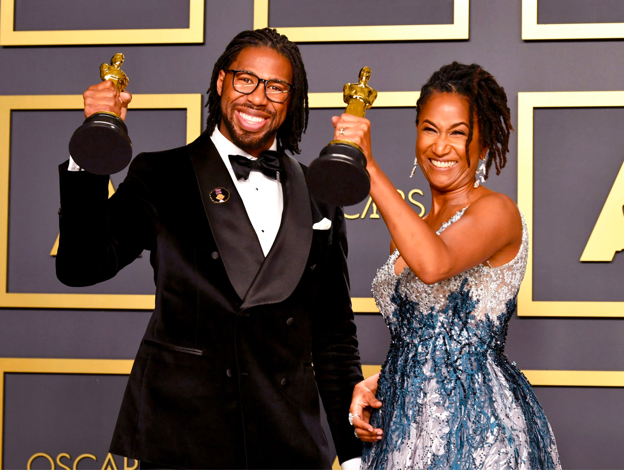 Matthew A. Cherry and Karen Rupert Toliver holding their Academy Awards for Hair Love