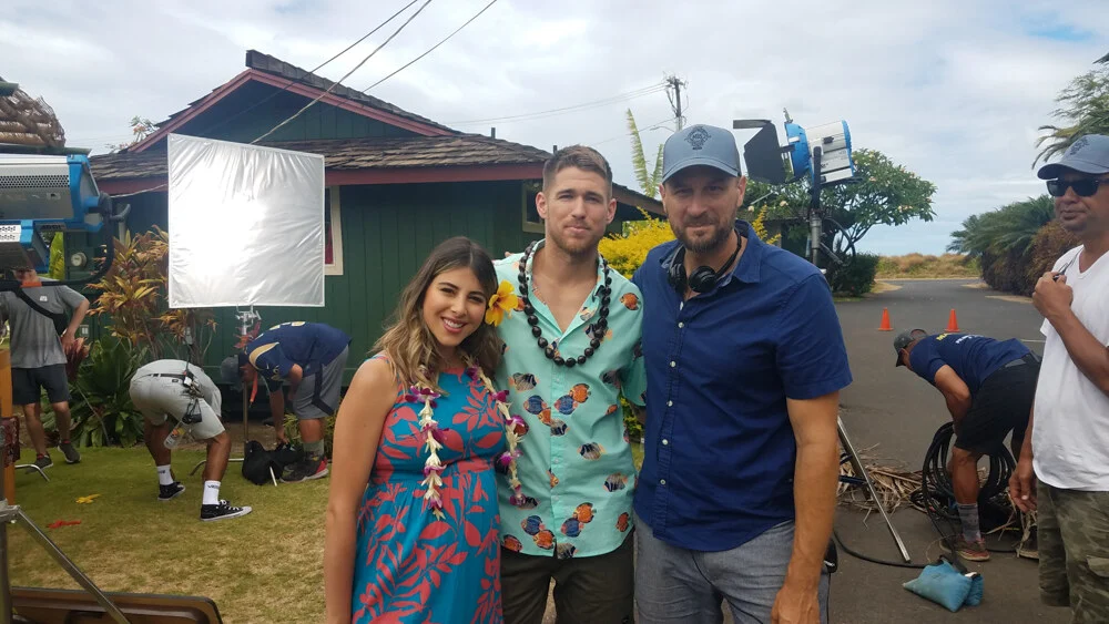 Cast and crew in leis outside a Maui cottage during filming
