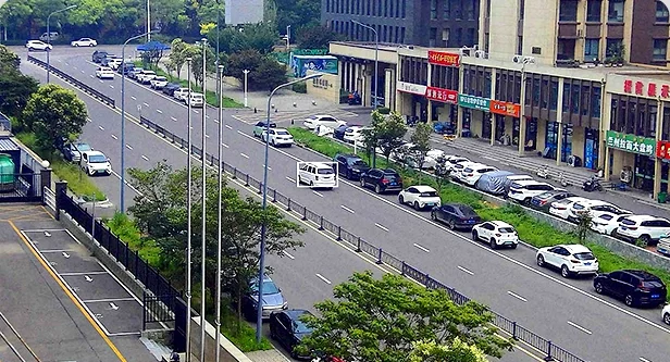 Street scene with one vehicle marked by a white tracking box