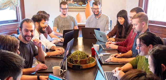 Real Coverbase team members working together at a table