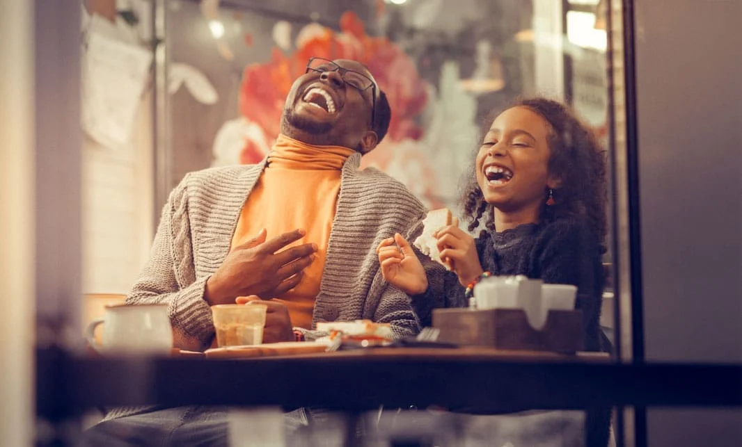 A father and daughter laughing together