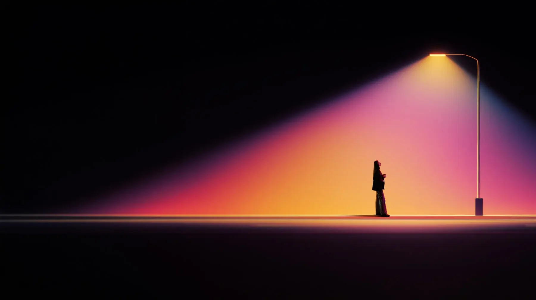 A person standing in light against a dark landscape