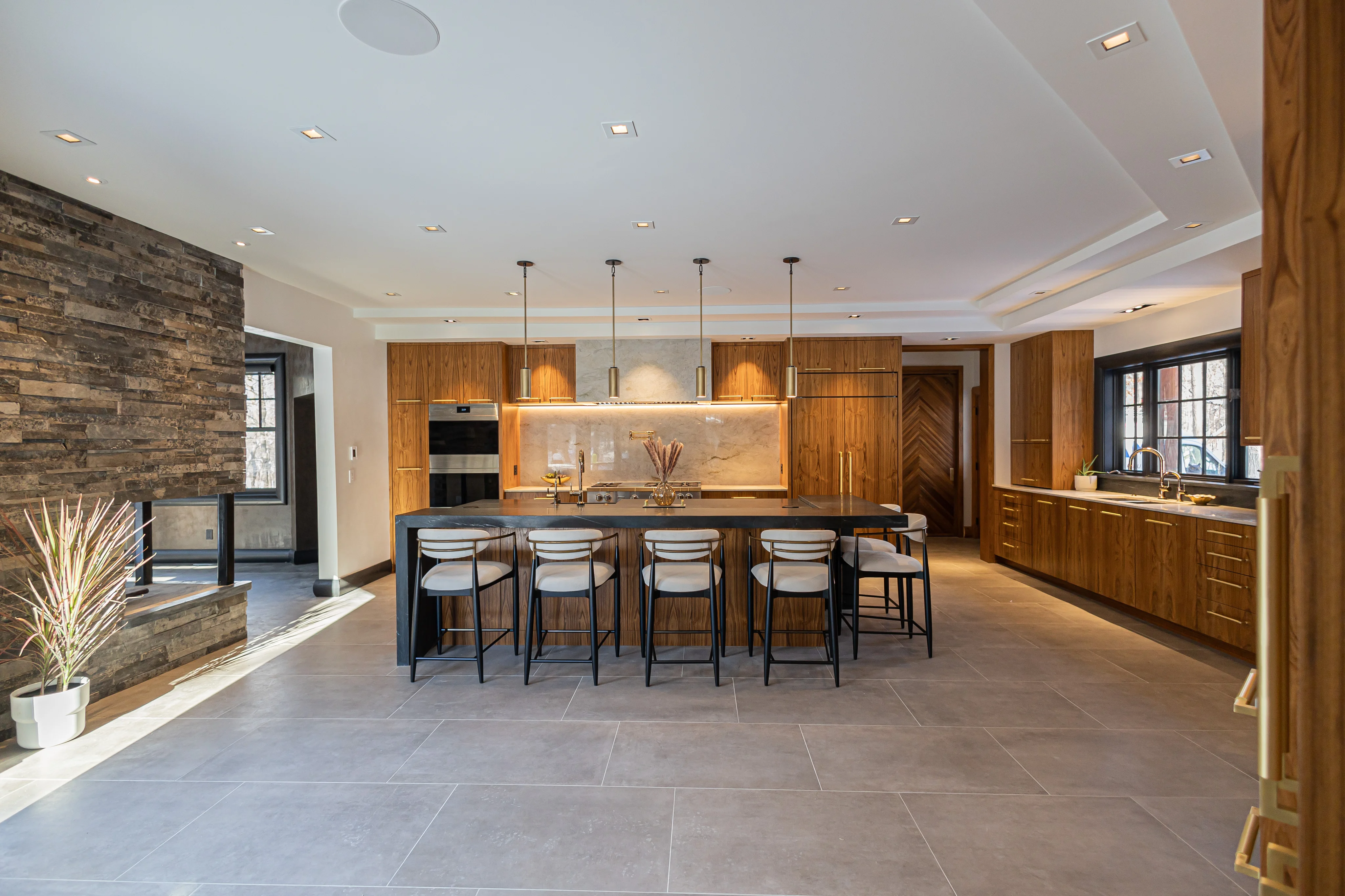 Lake Shore Drive kitchen with walnut cabinetry, black marble, and warm brass details