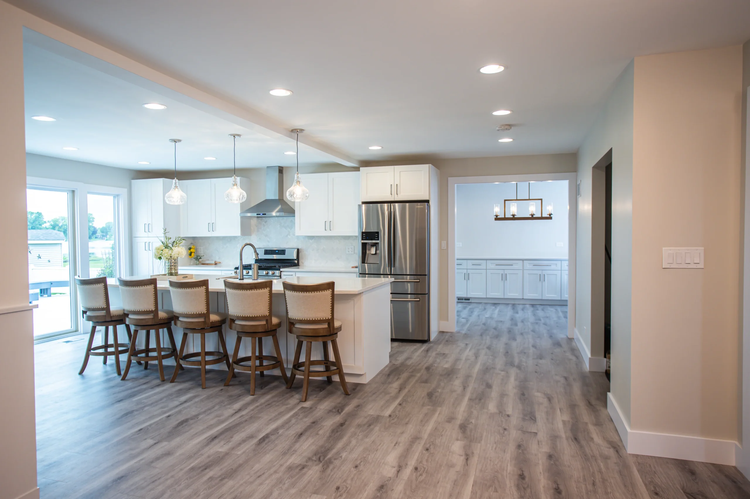Open concept white shaker kitchen with lake views