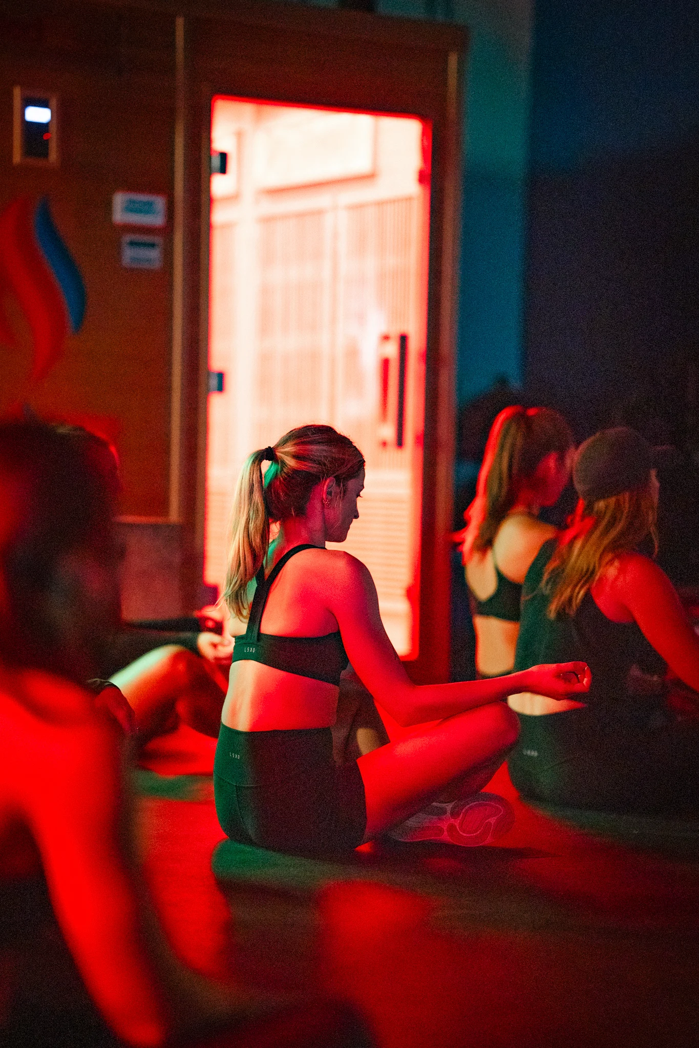 Sauna Strong members sitting together in a guided infrared recovery practice